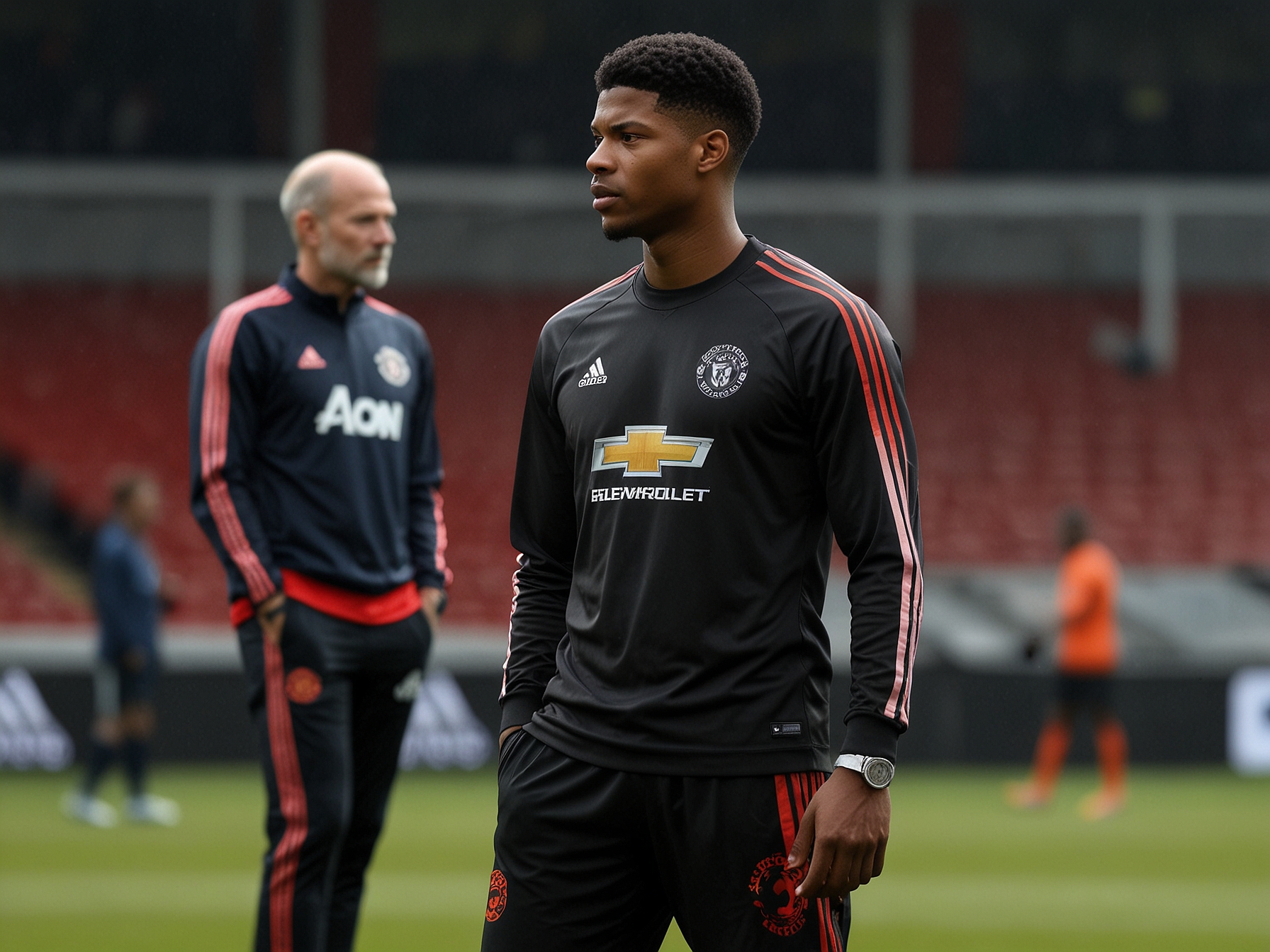 Erik ten Hag and Marcus Rashford in a deep conversation during a training session. This image signifies the pivotal discussions regarding Rashford's role and future at Manchester United under the new management.