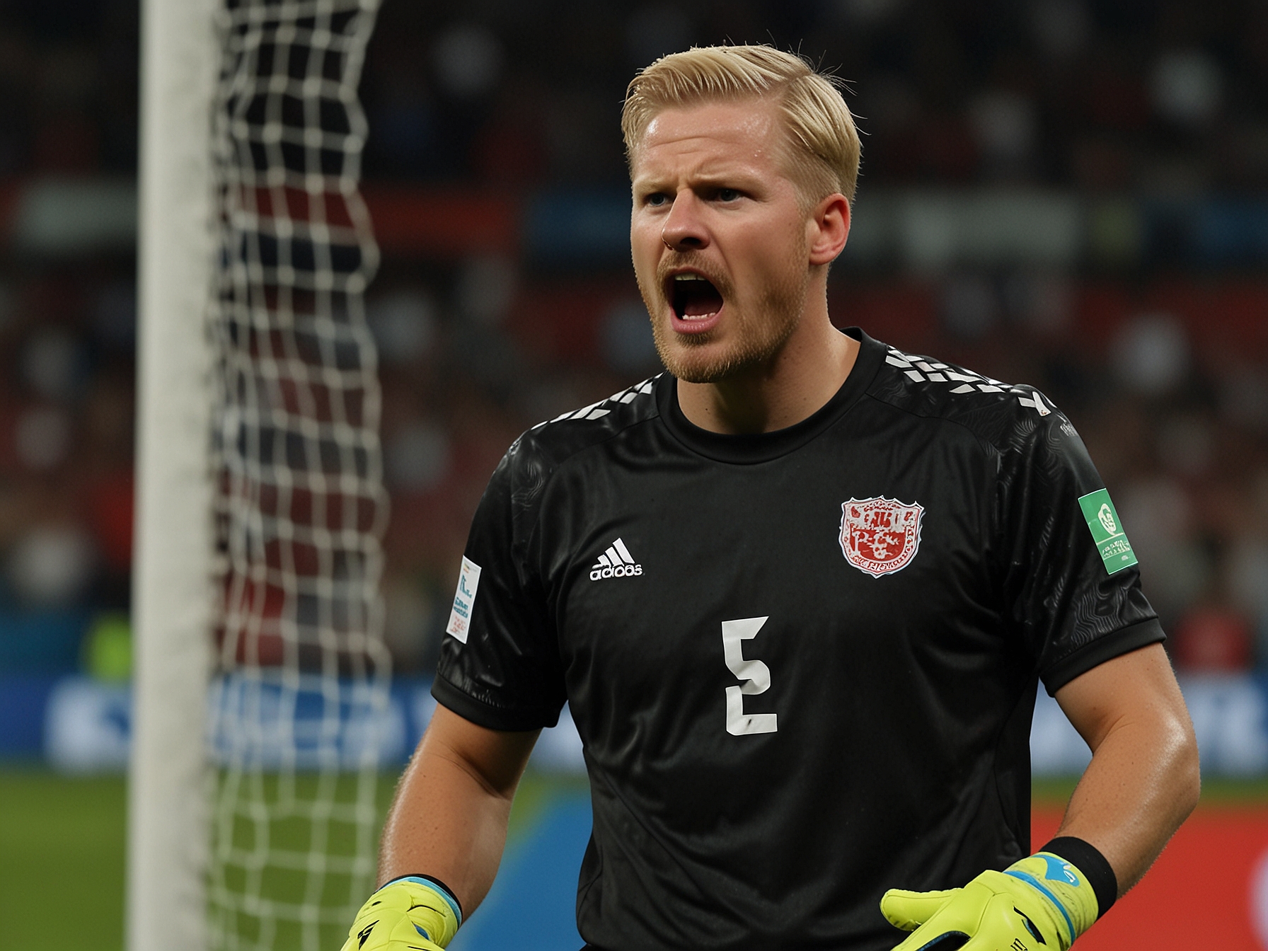 Denmark's goalkeeper, Kasper Schmeichel, during a tense moment in the Euro 2024 knockout game, visibly frustrated as he reacts to a controversial VAR decision on the field.